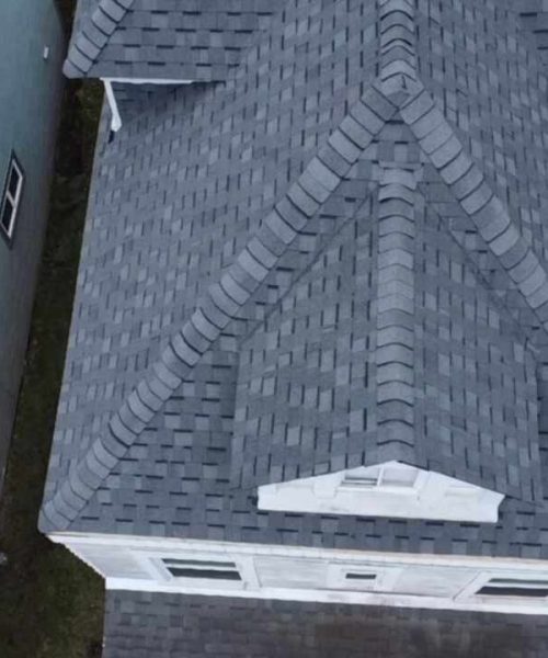 Aerial view of a newly installed gray shingle roof on a residential home, showcasing the quality roofing work by Alan Construction LLC in Pittsburgh, PA.