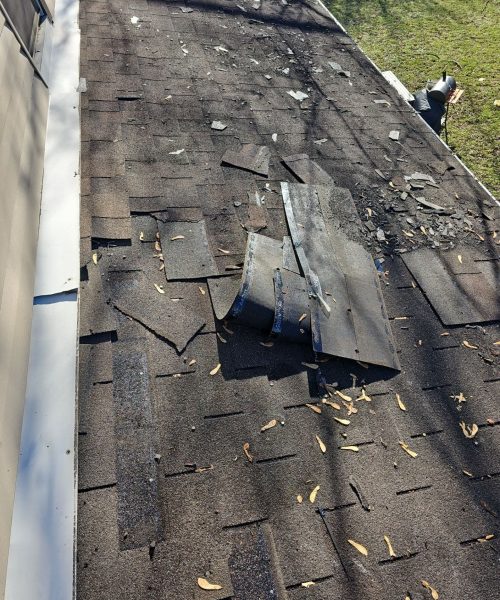 Old shingles lifting and broken along a gutter in East Pittsburgh, Alan Construction