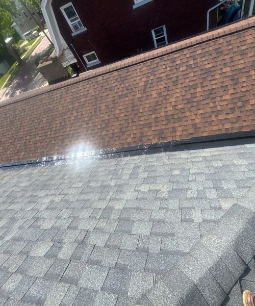New gray shingle roof meeting an upper brown shingle roof in Pittsburgh, Alan Construction