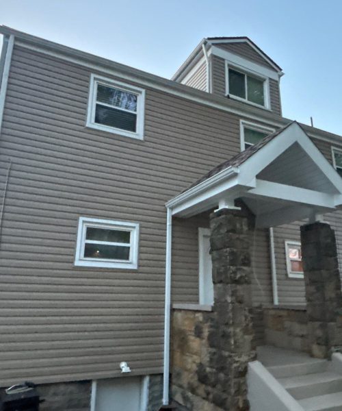 Two story home with new tan vinyl siding and white trim in Carnegie, Alan Construction