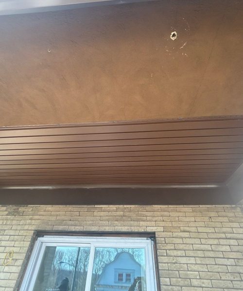 Porch ceiling with new soffit panels above a window in Pittsburgh, Alan Construction