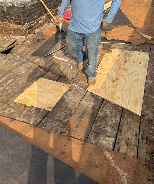 Damaged flat roof deck being repaired in Allentown