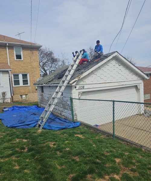 Tarps down for cleanup during a Brookline garage roof