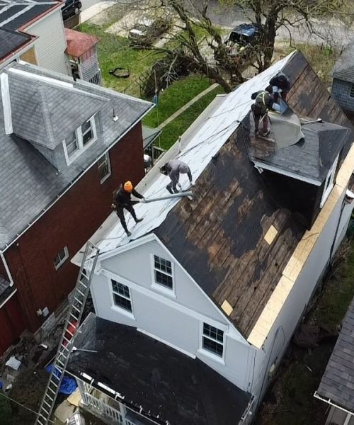 Aerial of a Dormont roof tear off between neighboring houses