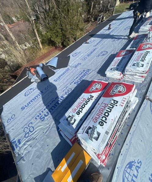 New shingle bundles staged on a Mount Lebanon roof